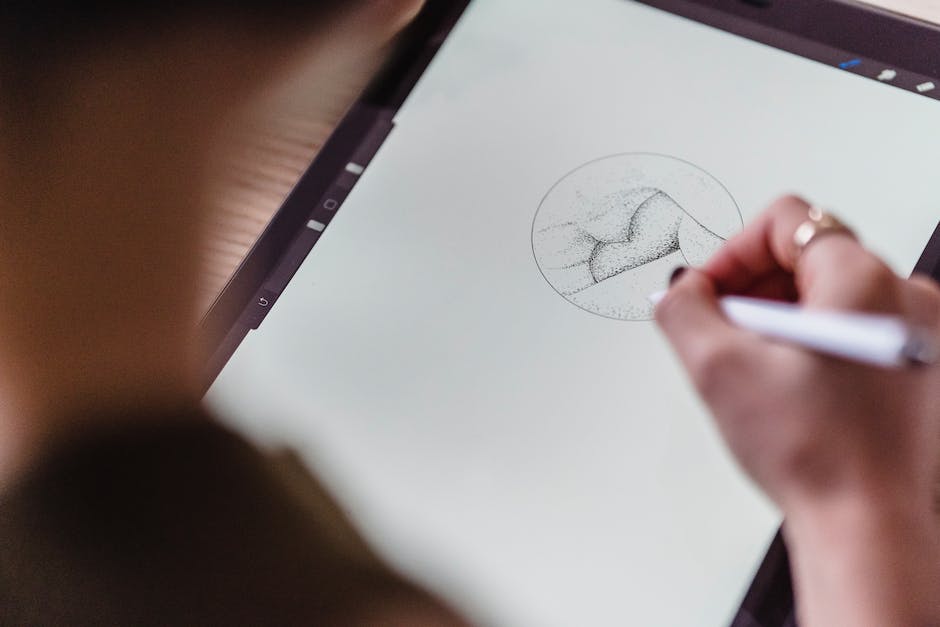 An image of a person using a digital tablet to create graphic designs, representing the concept of AI in graphic design.